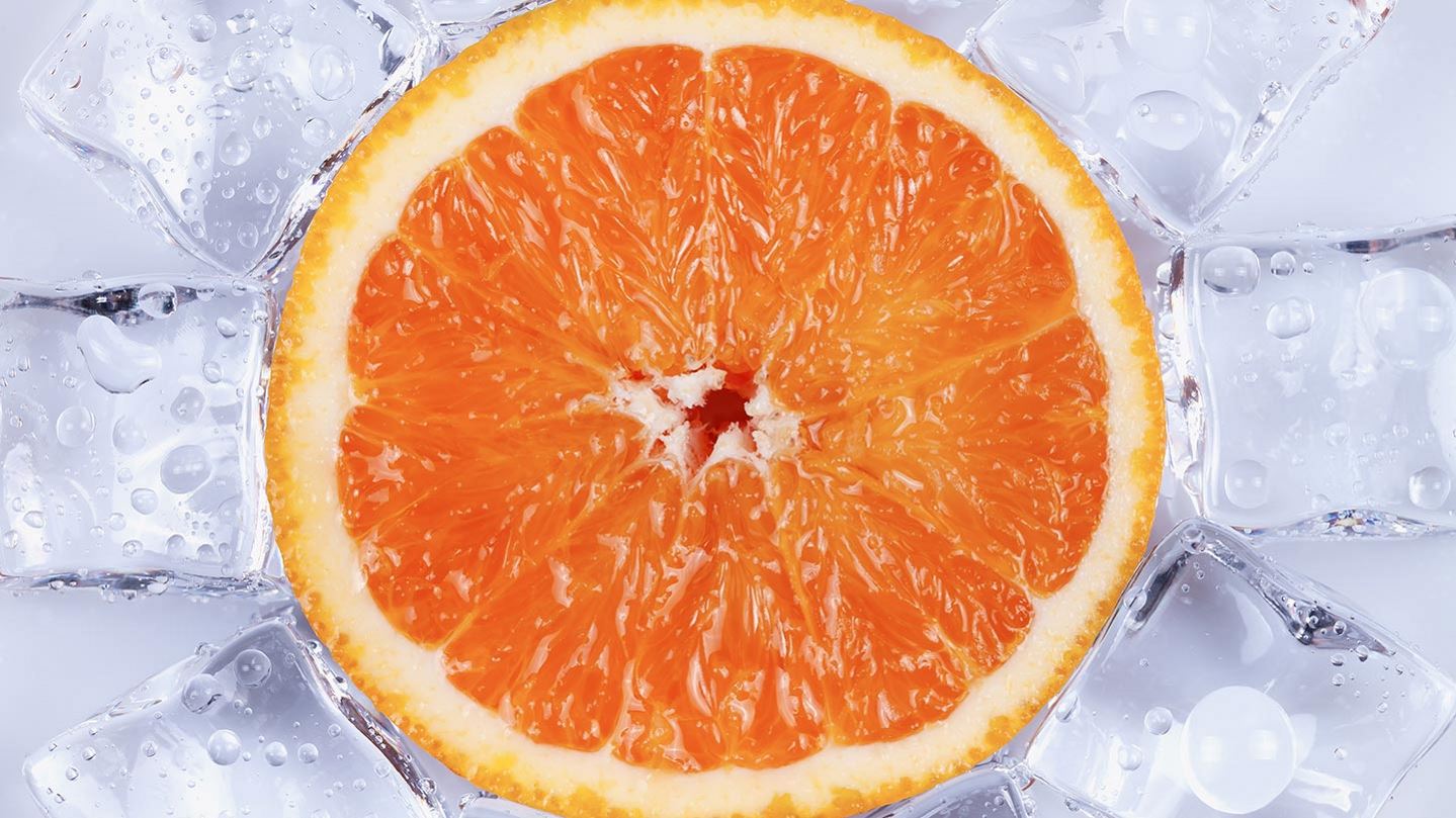 Orange surrounded by ice cubes