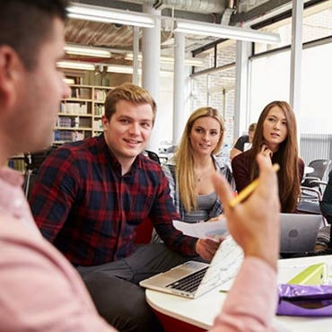 Employees sitting around conference table