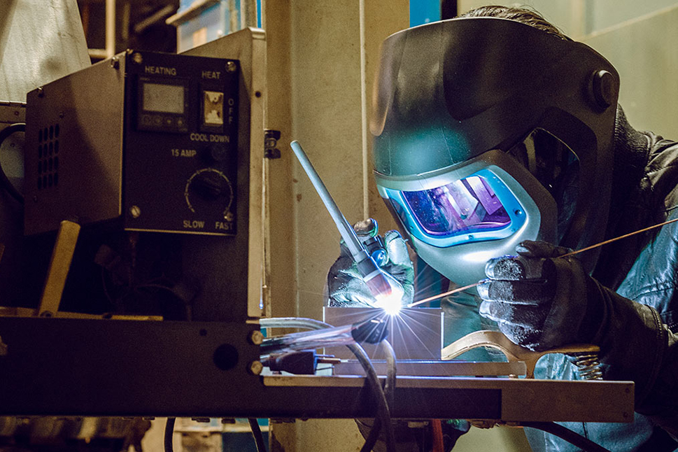 A tig welder working