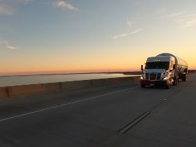 Air Products trcuk driving on road beside water